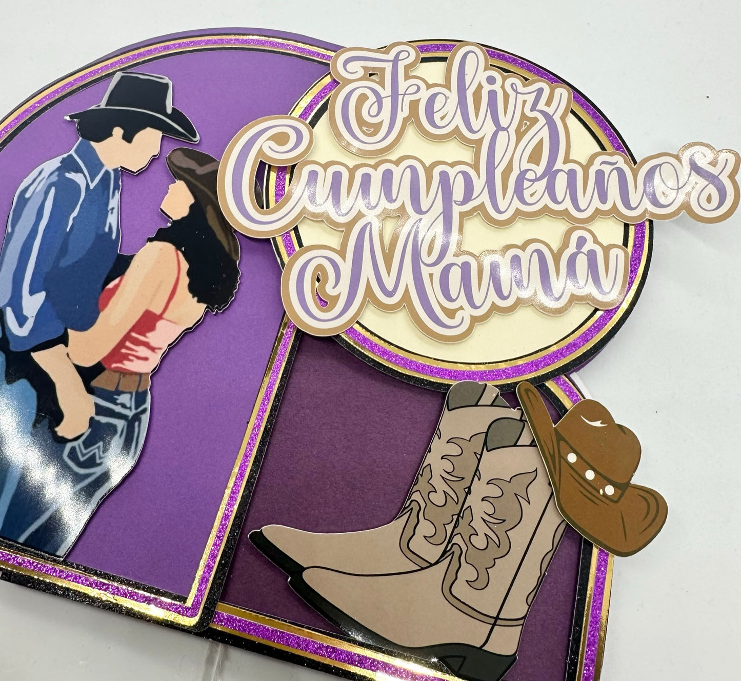 Close up view of Custom urban cowboy movie theme cake topper in purple and gold